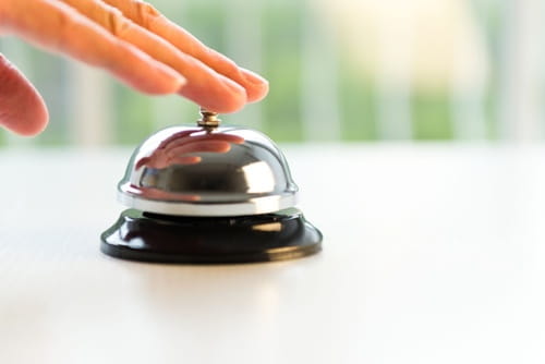image of hand ringing desk bell